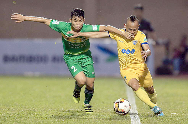 Nuti Cafe V.League 2018 bắt đầu “tách tốp” Trung vệ trẻ Tùng Quốc (trái) của Cần Thơ tranh chấp với cầu thủ Thanh Hóa trong trận hòa 1-1 cuối tuần trước. Ảnh: VPF