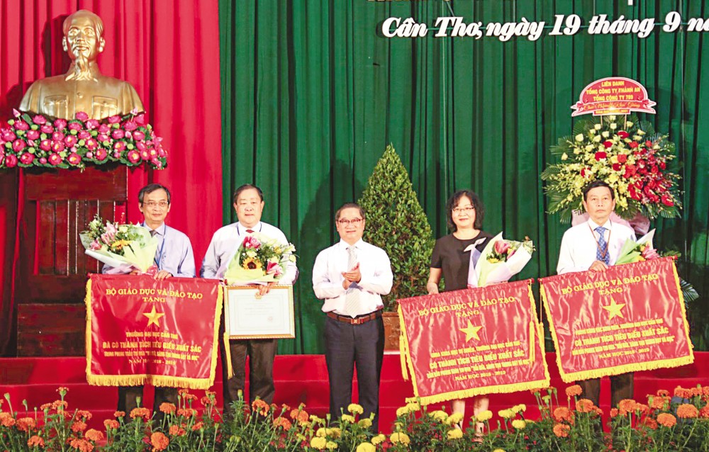 Đồng chí Trần Việt Trường, Ủy viên Ban Thường vụ, Trưởng Ban Tuyên giáo Thành ủy Cần Thơ, tặng Cờ thi đua của Bộ GD&ĐT cho tập thể Trường ĐHCT và 2 đơn vị thuộc trường. Ảnh: B.NG