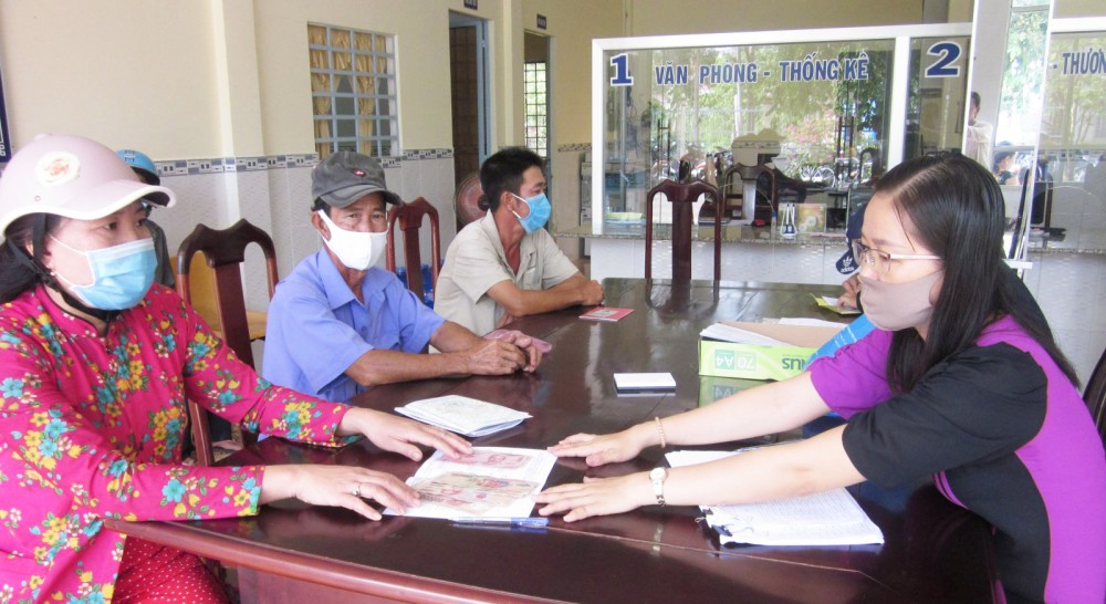 Người dân gặp khó khăn do dịch COVID-19 nhận tiền hỗ trợ tại xã Giai Xuân, huyện Phong Điền.
