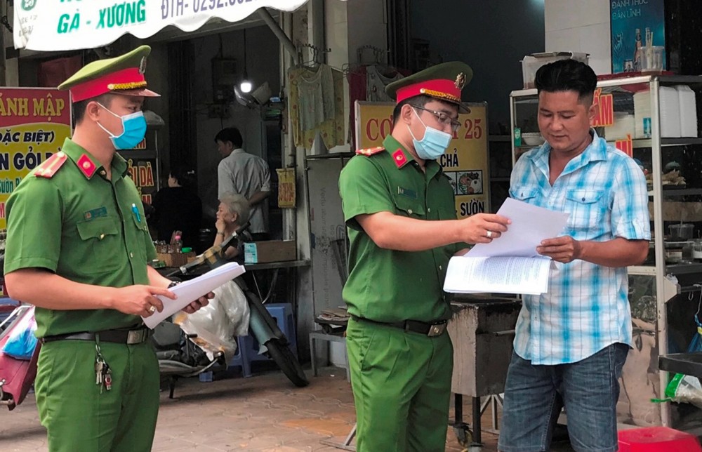 Công an phường Tân An phát tờ rơi tuyên truyền, vận động người dân tham gia giữ gìn trật tự đô thị.
