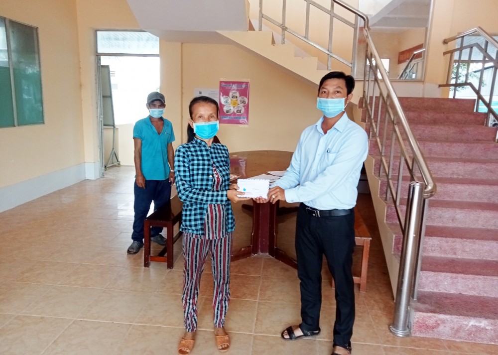 Ông Nguyễn Hoàng Nhiệm, Phó Chủ tịch UBND xã Thới Hưng, trao tiền hỗ trợ cho người lao động tự do trên địa bàn.