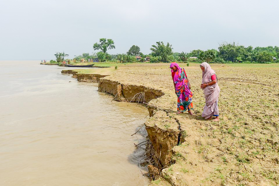Người dân Bangladesh quan sát tình trạng sạt lở tại bờ sông Padma. Ảnh: AFP