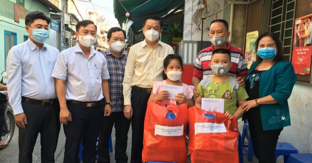 Ông Dương Tấn Hiển (thứ tư từ trái sang) trao quà hỗ trợ 2 trẻ mồ côi do dịch COVID-19.