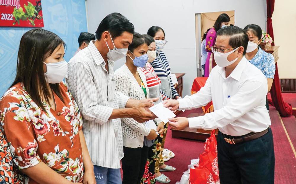 Đồng chí Trần Việt Trường tặng quà các hộ dân ở huyện Phong Điền. Ảnh: PHẠM TRUNG