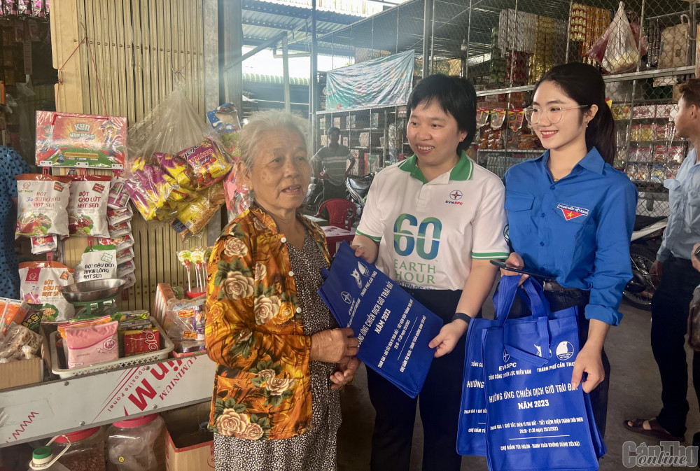Đoàn viên, thanh niên trao tặng túi thân thiện môi trường cho người mua bán ở chợ xã Thạnh Phú, huyện Cờ Đỏ.